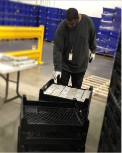 Worker recycling packages as part of CWT job.