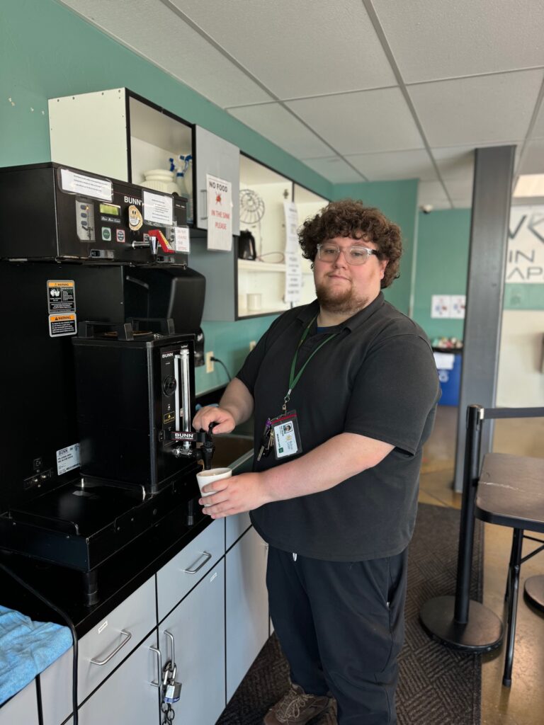 Job coach Alec Wilson gets coffee